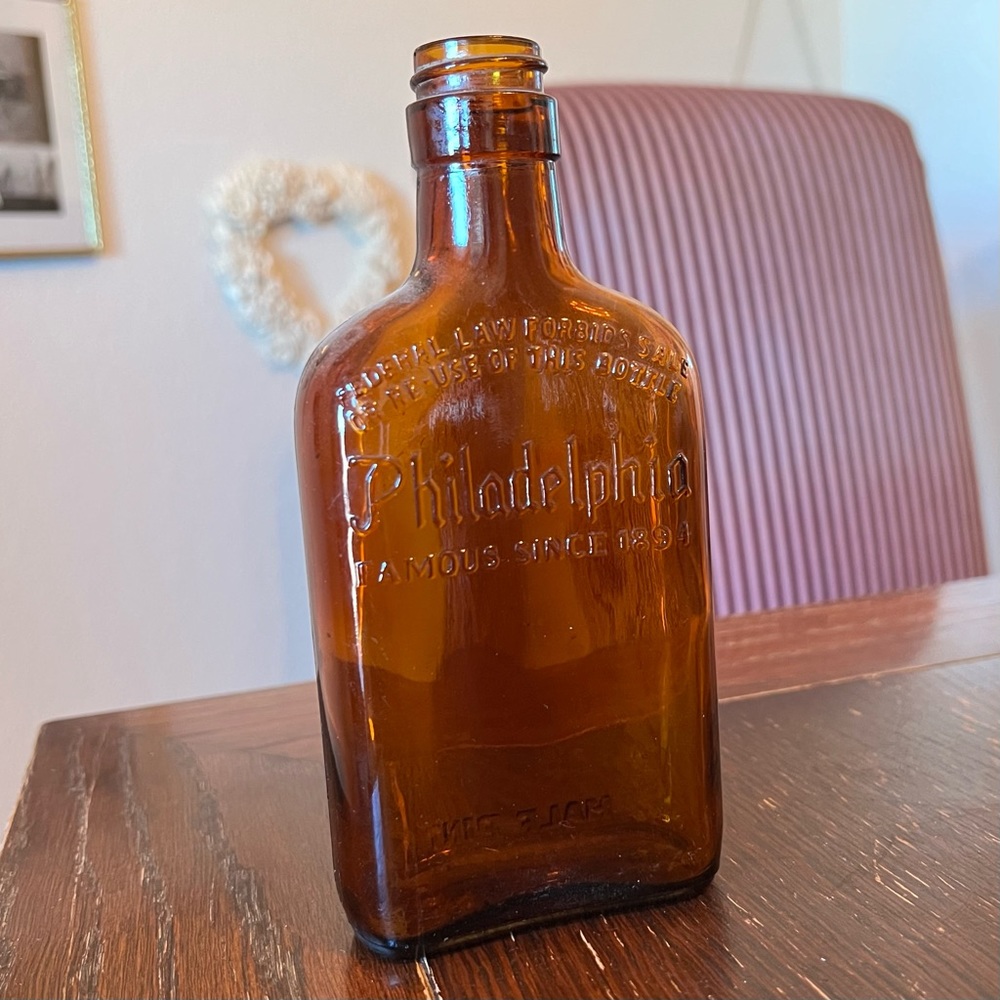 Vintage, embossed amber brown Philadelphia half pint bottle
